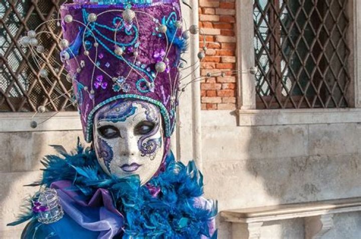 What do Venetian masks symbolize?